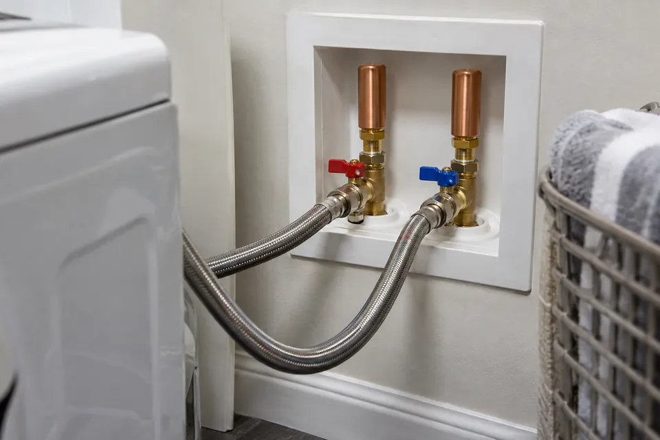 Washing-machine supply connections with compact water-hammer arrestors.